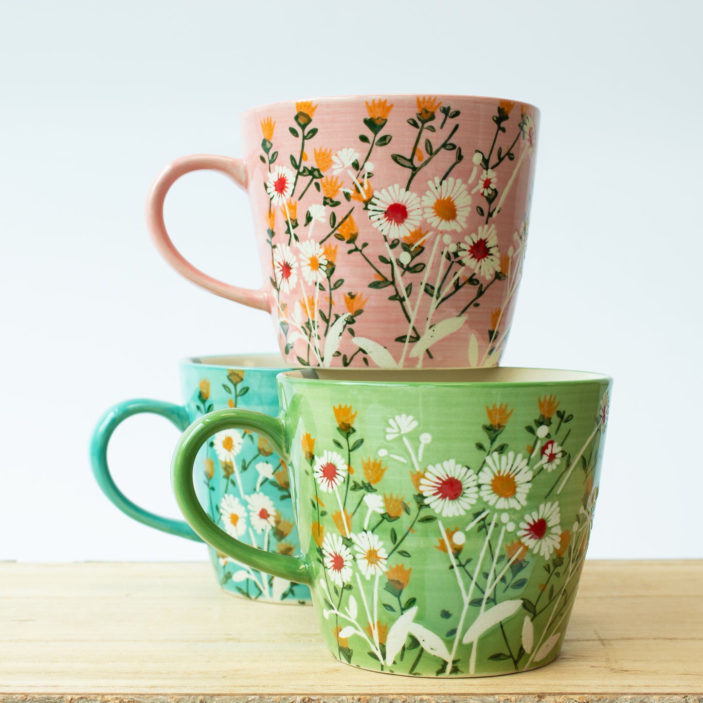 stack of three mugs - pink, green, blue