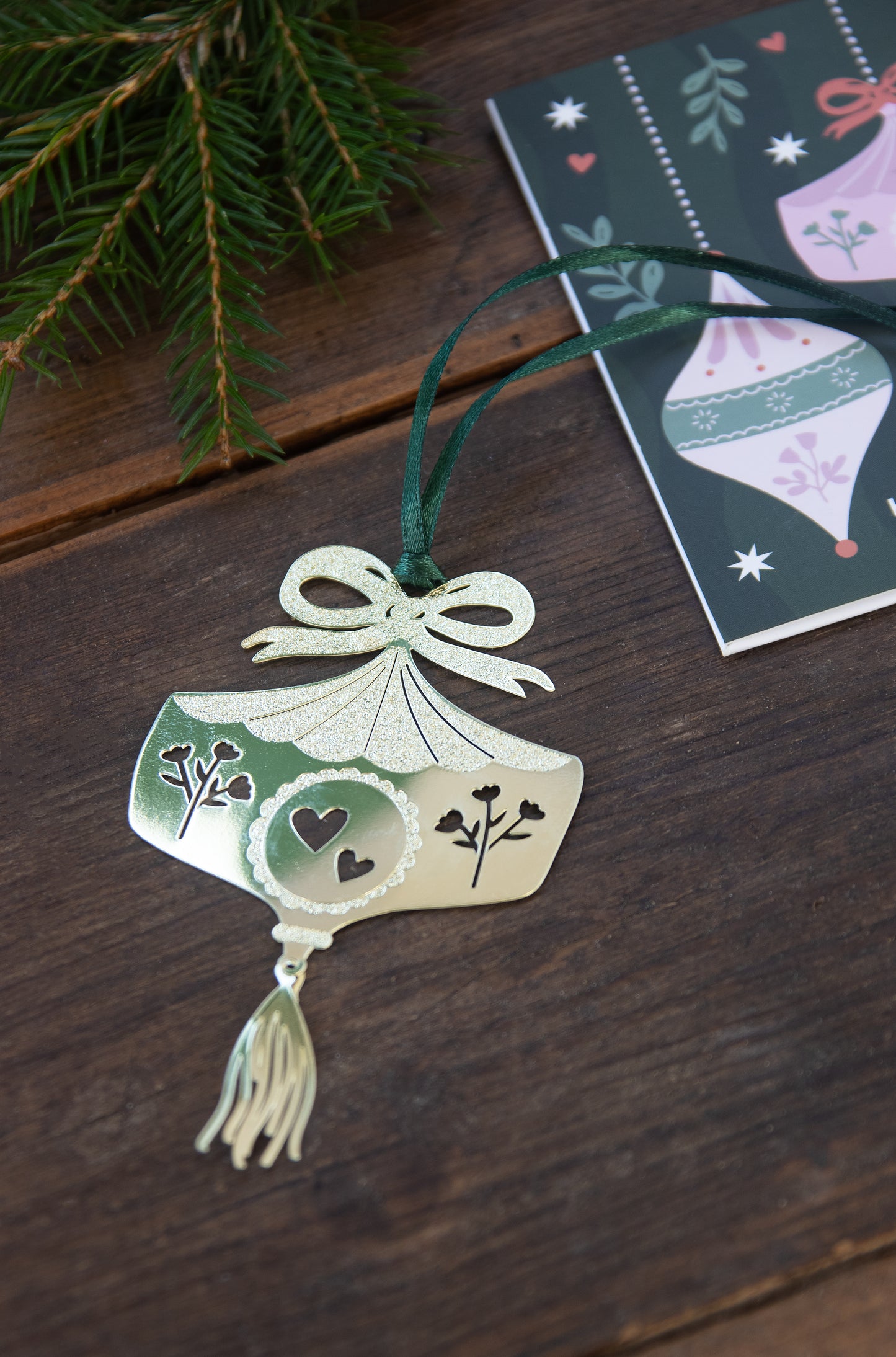 Decorative ornament with green and white design on a wooden surface