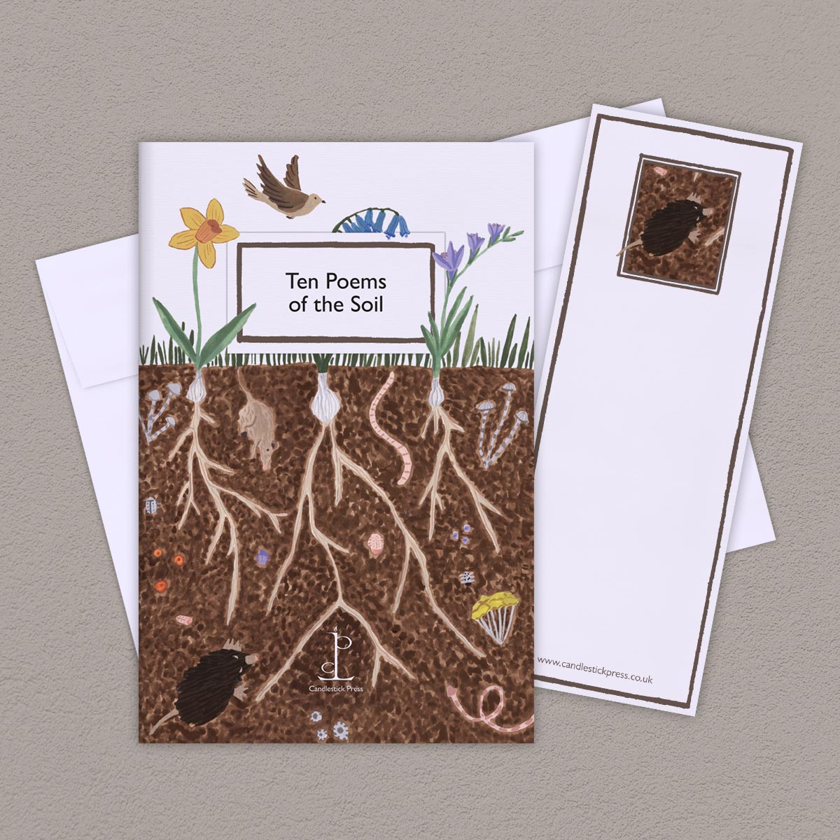 The Poem Pamphlet, 'Ten Poems of the Soil' sits on a light grey background with the bookmark and white envelope.