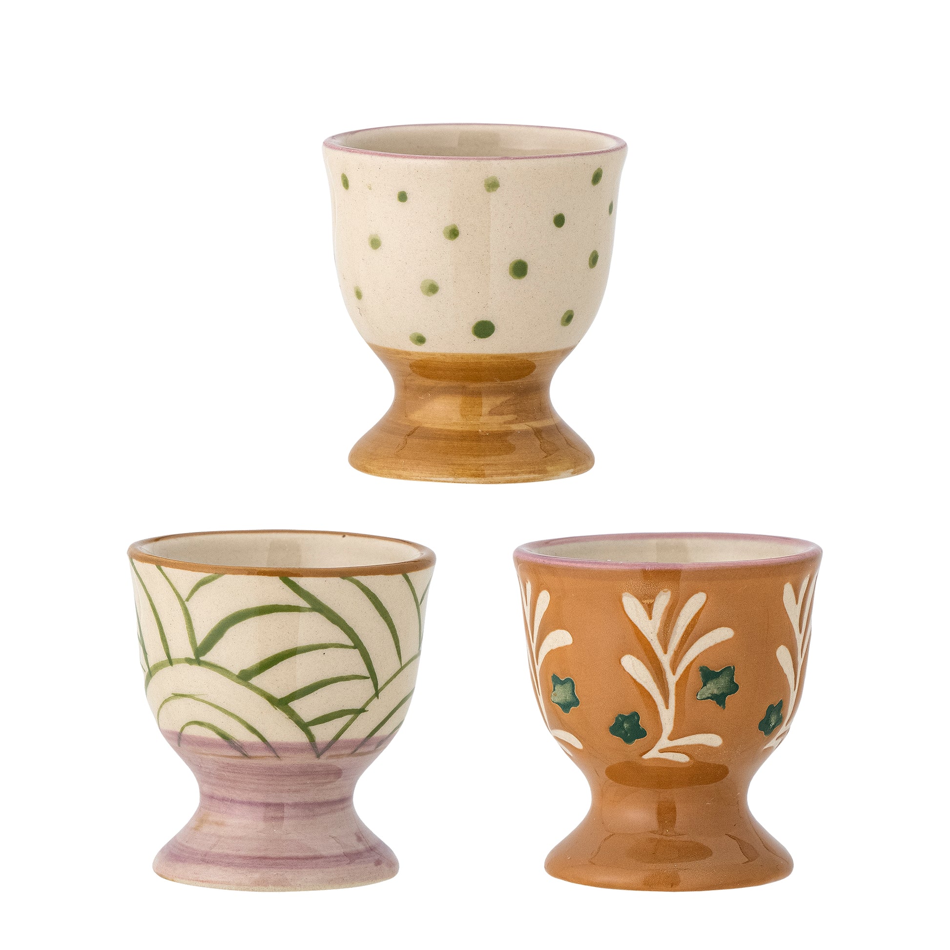 Trio of egg cups on white background