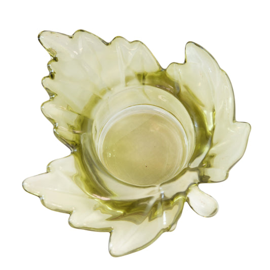 Green glass candle holder on a white background