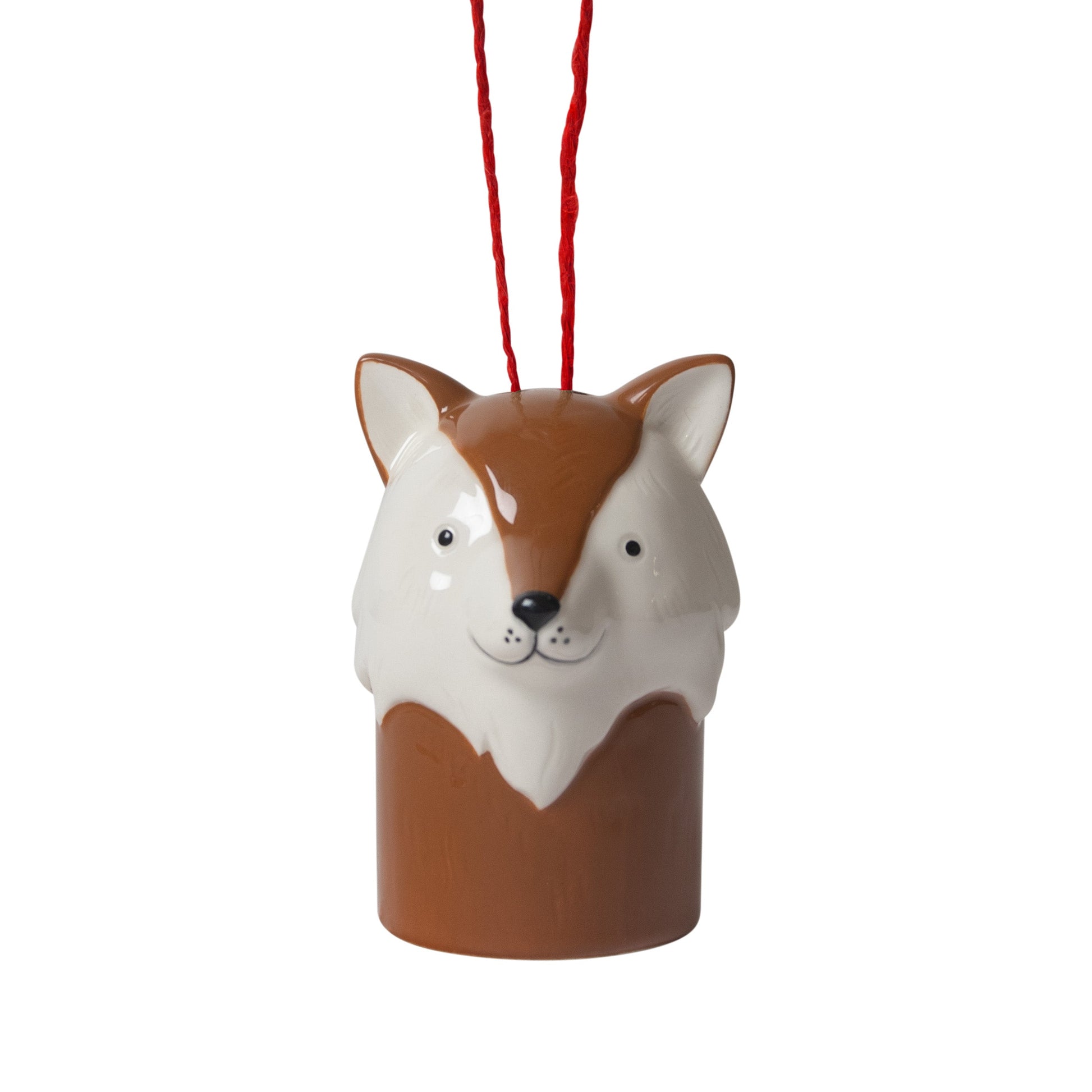 Fox-shaped ornament with a red string on a white background