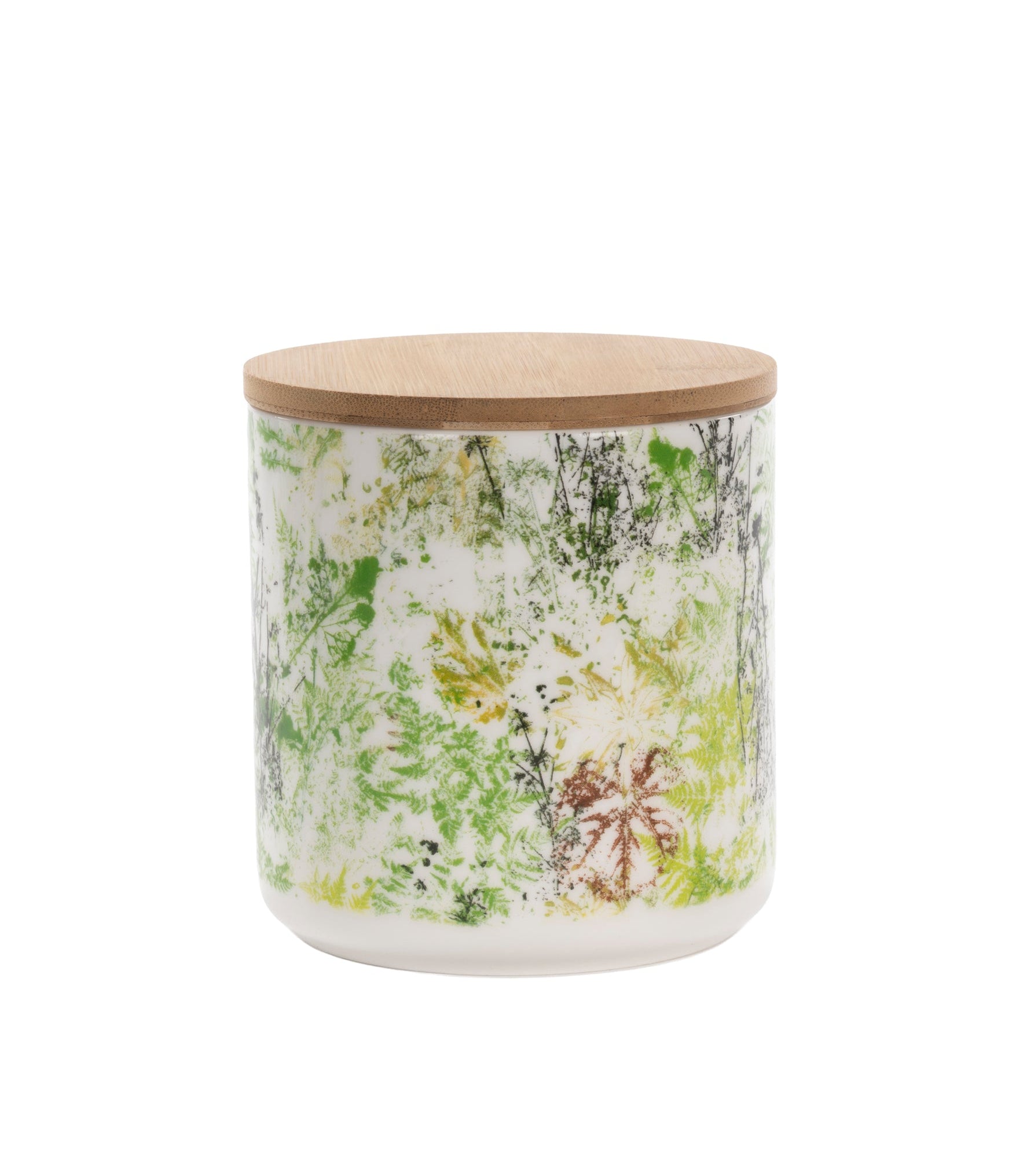 A cylindrical glass jar candle with a light natural wood lid, featuring a white body decorated with a green and yellow botanical leaf pattern.