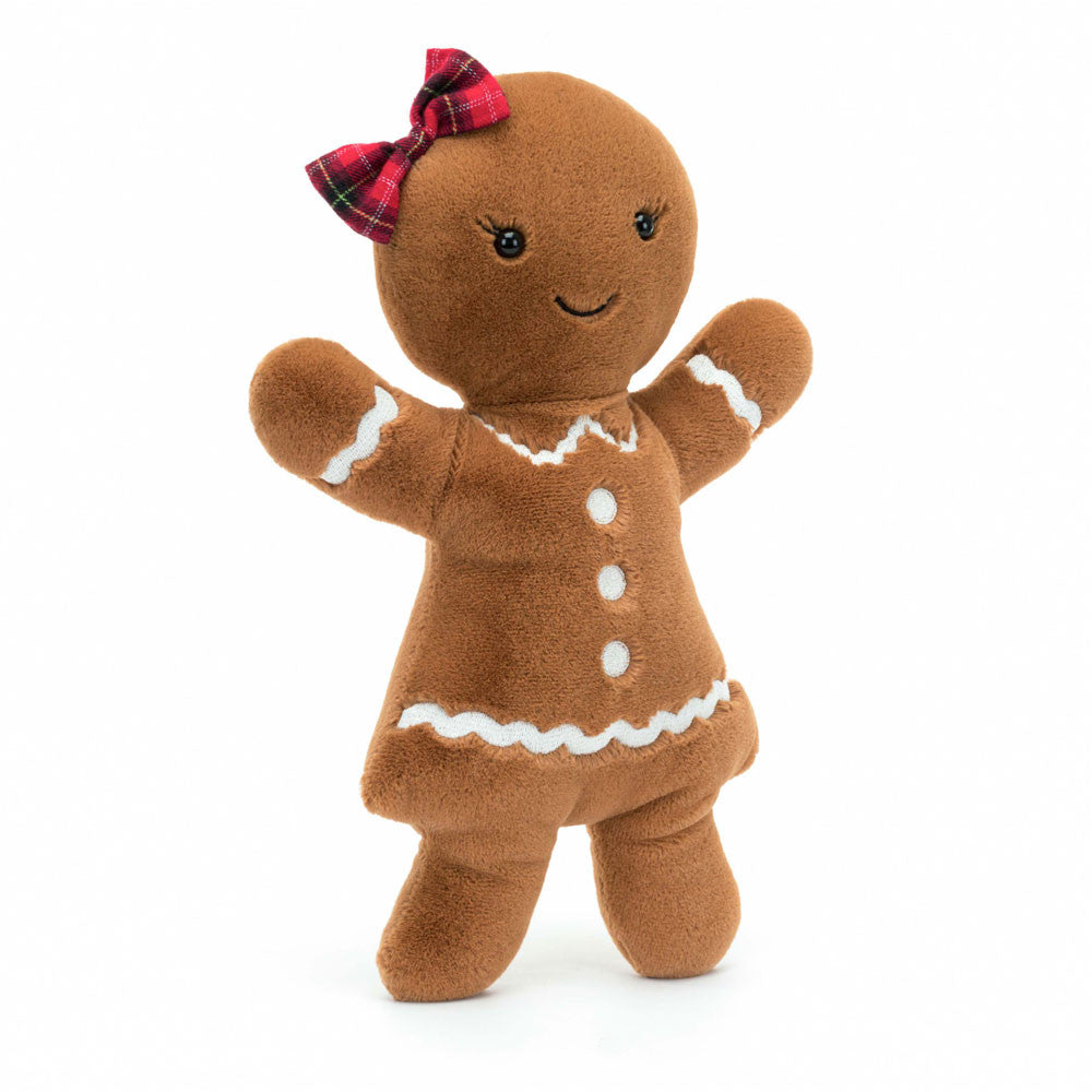 Stuffed gingerbread girl with a plaid bow on a white background