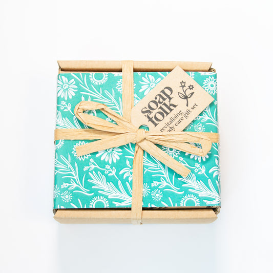 Gift set with floral wrapping and bow on a white background