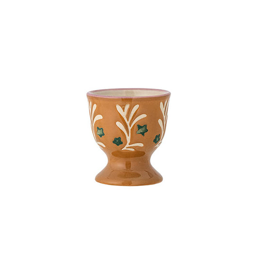 Brown egg cup with hand painted green stars and an abstract white vine. 