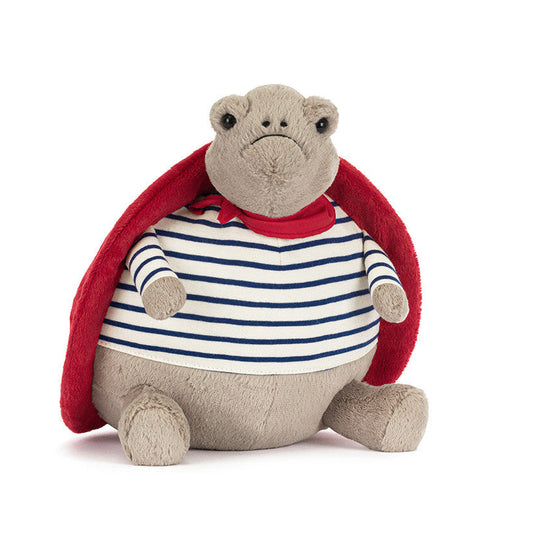 Stuffed toy with a red cape and striped shirt on a white background