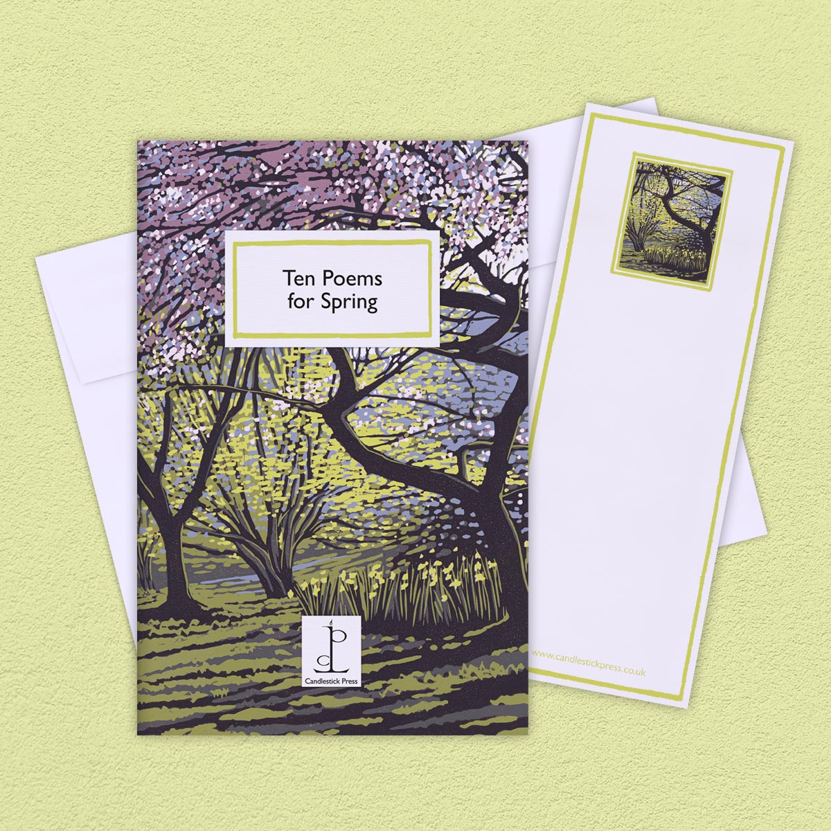 The Poem Pamphlet, 'Ten Poems about Spring' sits on a light yellow background with the bookmark and white envelope.