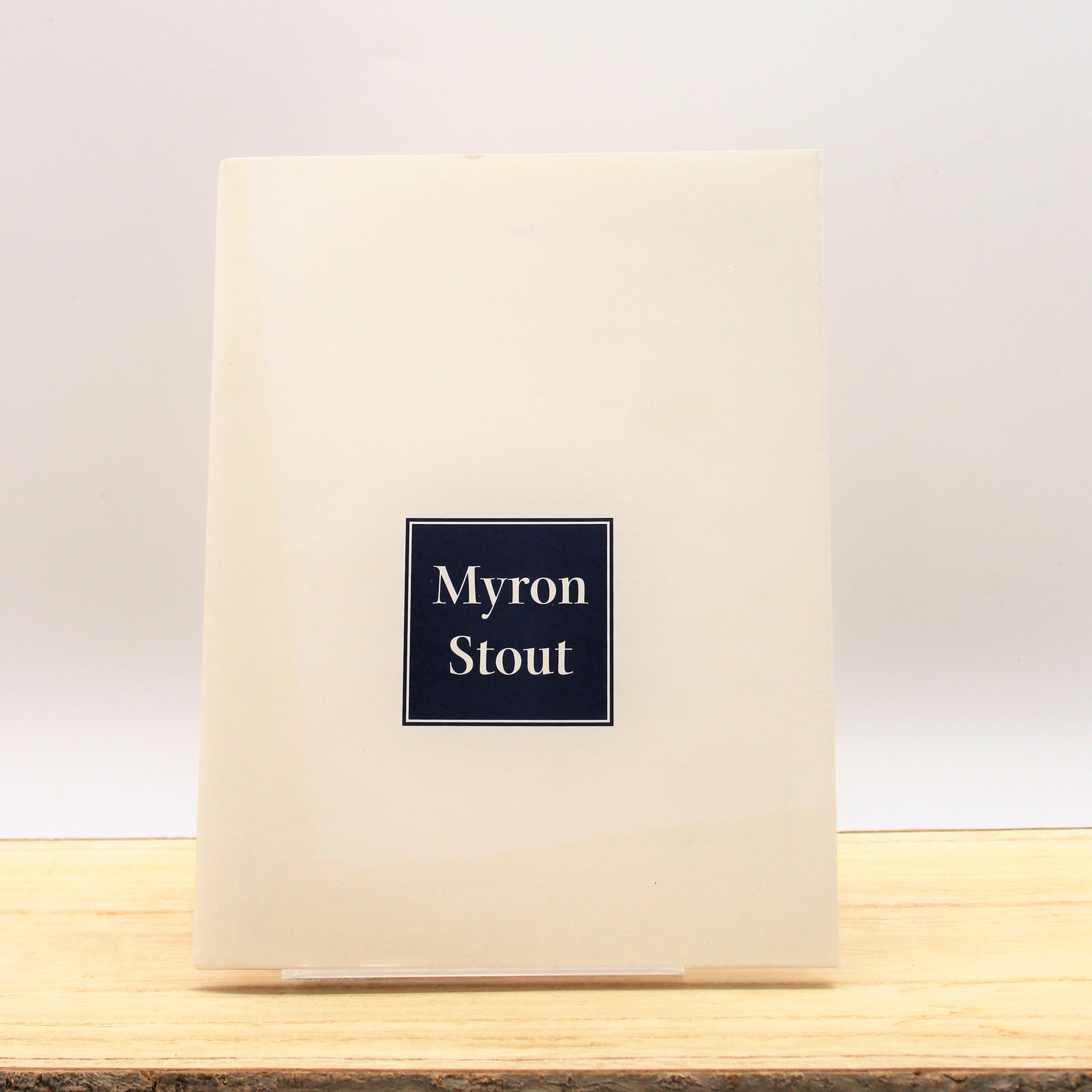 Cover of the book 'Myron Stout' with a simple design featuring the artist's name and a geometric shape in the center.